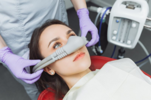 Dental patient receiving laughing gas but looks slightly alarmed